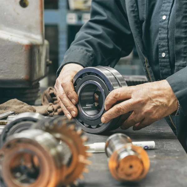 A man's hands holding wheel shaped equipment